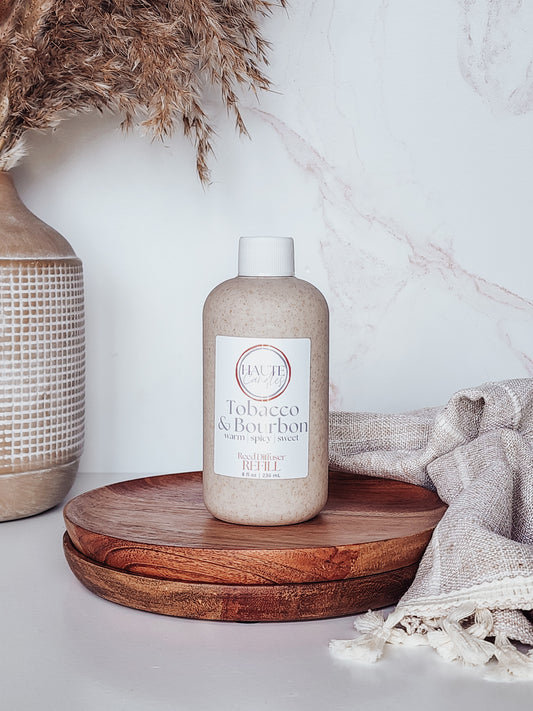 Bottle of 'Tobacco & Bourbon' on a wooden tray with decorative elements